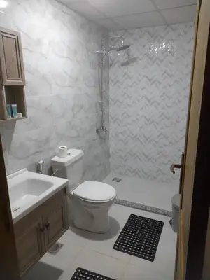 a bathroom with a toilet and a shower and a sink at wadi rum gem in Disah
