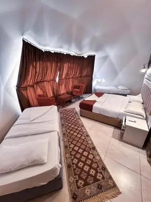 a bedroom with two beds in a room at wadi rum gem in Disah