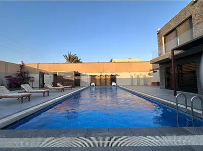 a swimming pool in front of a building at SunValley in Al Rama