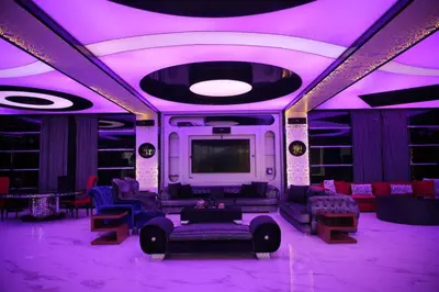 a living room with purple lighting and a tv at Luxurious private villa in Mahis in Māḩiş