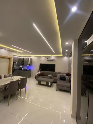 a living room with a couch and a table at Nabila Chalet in Sowayma