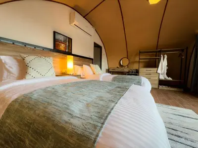 a large room with two beds in it at Moon night camp in Disah