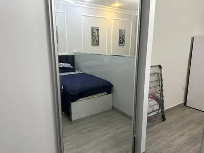 a mirror reflection of a bedroom with a bed in it at استوديو الجاردنز gardens studio 319 in Al Jafr