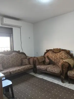 a living room with two large couches in a room at ام الينابيع عجلون in Ajloun