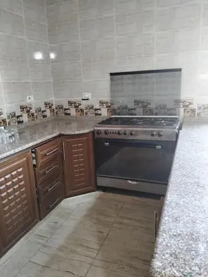 a kitchen with a stove and a counter top at ام الينابيع عجلون in Ajloun