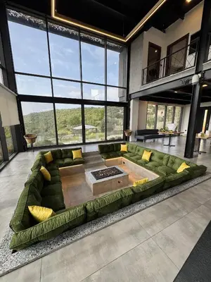 a large living room with a large green couch at AlFahed Farm in Ajloun