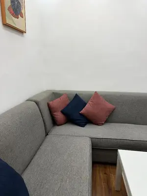 a gray couch with pillows on it in a living room at استوديو الرابية 19 studio alrabyeh in Al Jafr