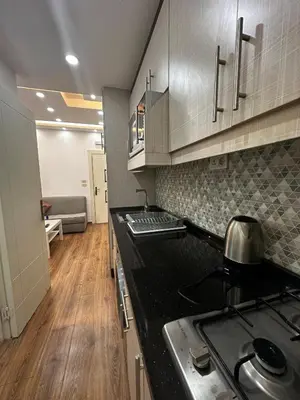 a kitchen with a stove and a counter top at استوديو الرابية 19 studio alrabyeh in Al Jafr