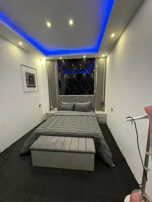 a bedroom with a large bed with a blue ceiling at Studio in the Heart of Irbid in Irbid