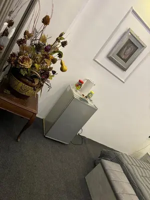 a room with a vase of flowers on a table at Studio in the Heart of Irbid in Irbid