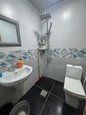 a bathroom with a sink and a toilet and a mirror at Studio in the Heart of Irbid in Irbid