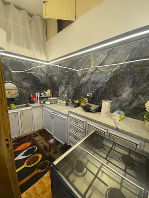 a kitchen with a counter and a stove in it at Studio in the Heart of Irbid in Irbid