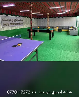 a ping pong table in a room with a ping pong ball at Enjoy moment chalet