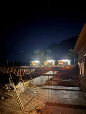 a view of a building at night with lights at Adventure Nights Camp in Wadi Rum