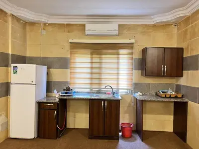 a kitchen with a sink and a refrigerator at الفاخر للشقق الفندقيه in Al Mafraq
