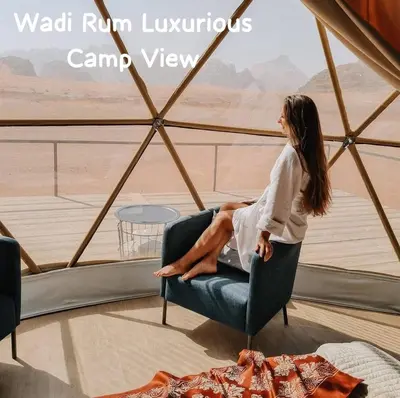 a woman sitting in a chair in a room with a view at Wadi Rum Luxurious Camp View in Wadi Rum