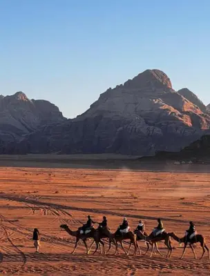 a group of people riding horses in the desert at Wadi Rum Luxurious Camp View in Wadi Rum