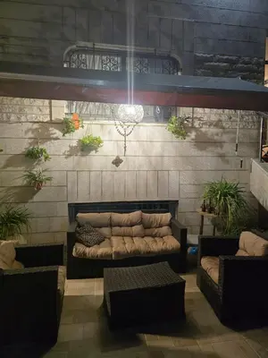 a living room with a couch on a wall at Le Jardin in Madaba