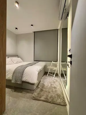 a bedroom with a bed and a large screen at Luxury Roof-top in Amman