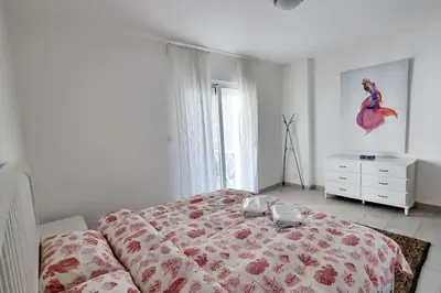 a bedroom with a bed with a bird on the wall at Island Apartment in Aqaba
