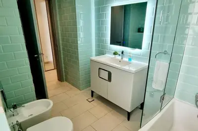 a bathroom with a sink and a toilet and a shower at Island Apartment in Aqaba