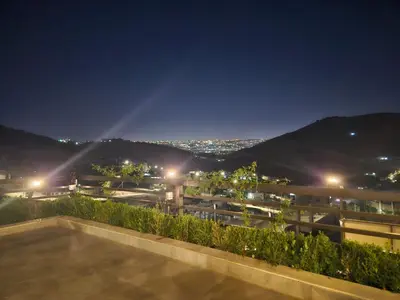 a view from the roof of a building at night at Sorjat Al Tal Chalet in Umm Tall