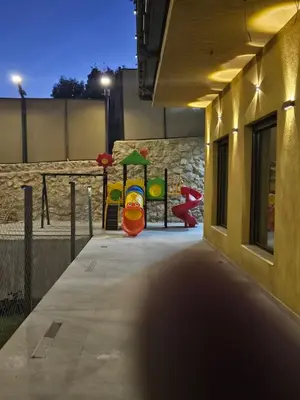 a childrens playground with two slides at Sorjat Al Tal Chalet in Umm Tall