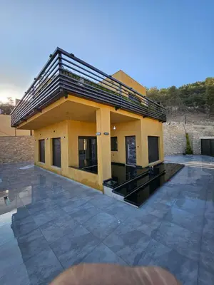 a small house with a large patio at Sorjat Al Tal Chalet in Umm Tall
