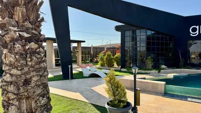 a resort with a swimming pool and a building at Giving City in Amman