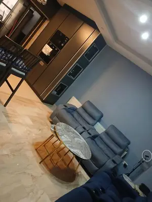 a living room with a couch and a table at Five-star hotel apartment in Amman