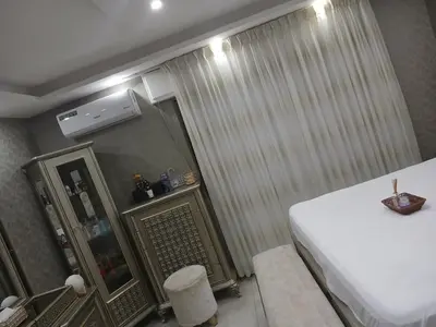 a hotel room with a bed and a window with aperature at Five-star hotel apartment in Amman