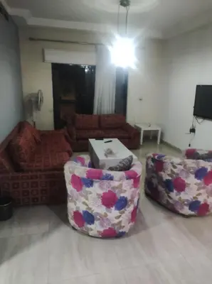 a living room with two chairs and a couch at Amman in Amman