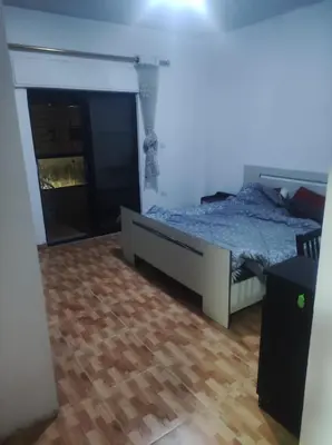 a bedroom with a bed and a wooden floor at Amman in Amman
