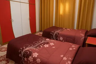 a hotel room with two beds and a couch at الخير شقق مفروشه in Al Jafr