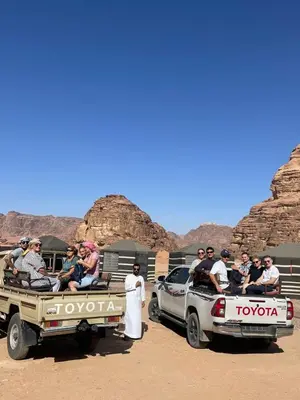 a group of people sitting on the back of a truck at Wahj Ram camp in Aqaba
