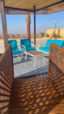 a group of chairs and a table on a patio at Al Eman Oasis Farm in Jal‘ad