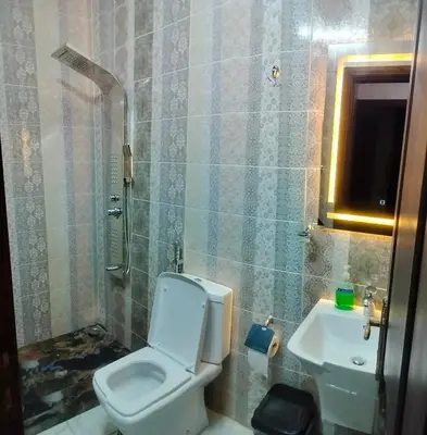 a bathroom with a toilet and a sink at Ayla Furnished Apartments in Aqaba