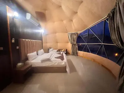 a bedroom with a bed in a tent at Layla Wadi Rum in Disah