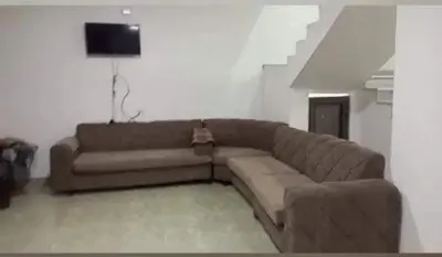 a living room with a couch and a tv at Grand farm