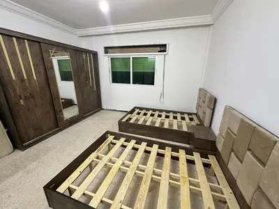 a room with two beds and a door at Beautiful apartment in Irbid