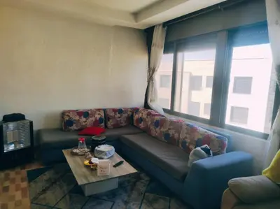 a living room with a couch and a table at الدوار السابع in Amman