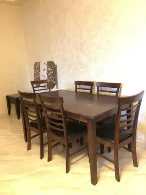 a wooden table with four chairs and a table and a table and chairsktop at Apartment in the heart of Amman in Amman