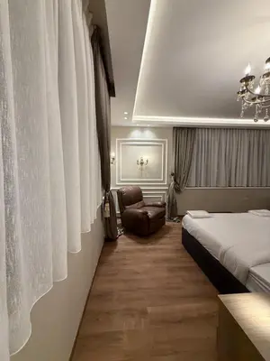 a hotel room with a bed and a chair at amazing rooftop-studio at abdoun 702 in Amman