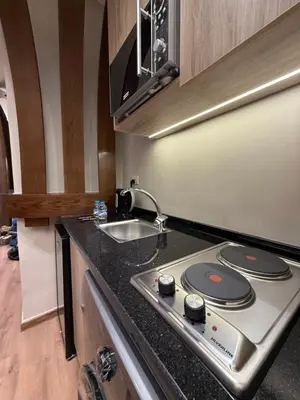 a kitchen with a stove and a sink at amazing rooftop-studio at abdoun 702 in Amman