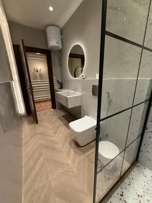 a bathroom with a toilet and a sink and a mirror at amazing rooftop-studio at abdoun 702 in Amman