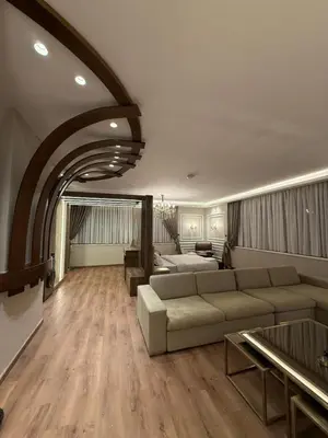 a large living room with a couch and a table at amazing rooftop-studio at abdoun 702 in Amman