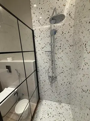 a shower in a bathroom with a toilet at amazing rooftop-studio at abdoun 702 in Amman