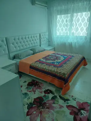 a bedroom with a bed with a floral rug at Dream Home furnished Apartment in Amman