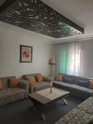 a living room with couches and a coffee table at Dream Home furnished Apartment in Amman