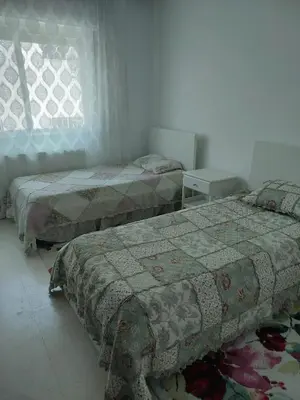 a bedroom with two beds and a window at Dream Home furnished Apartment in Amman